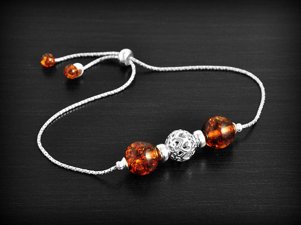 Bracelet en argent et ambre cognac, longueur réglable avec boule délicatement filigranée argent...